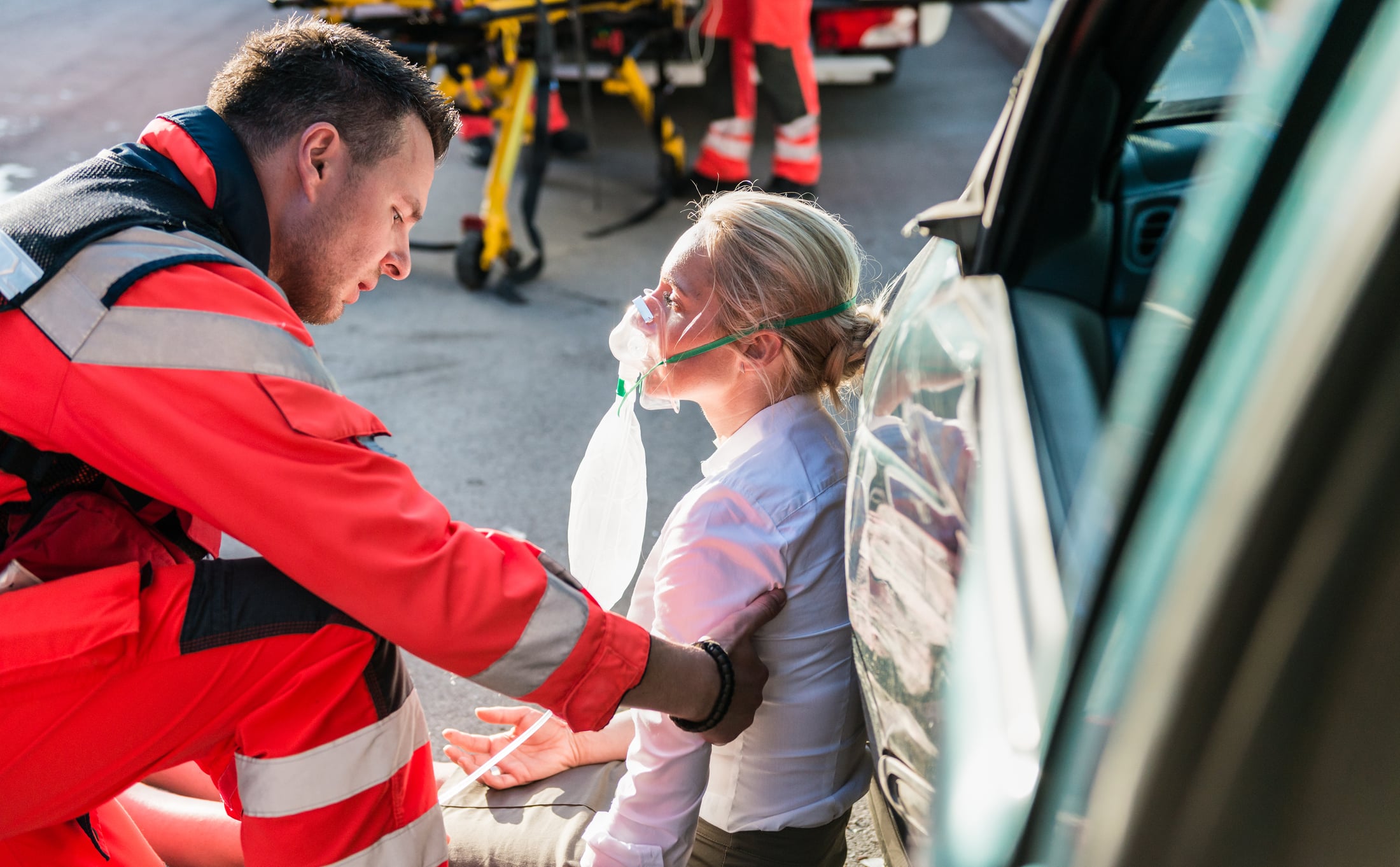 A woman being treated by an EMT after a truck accident.