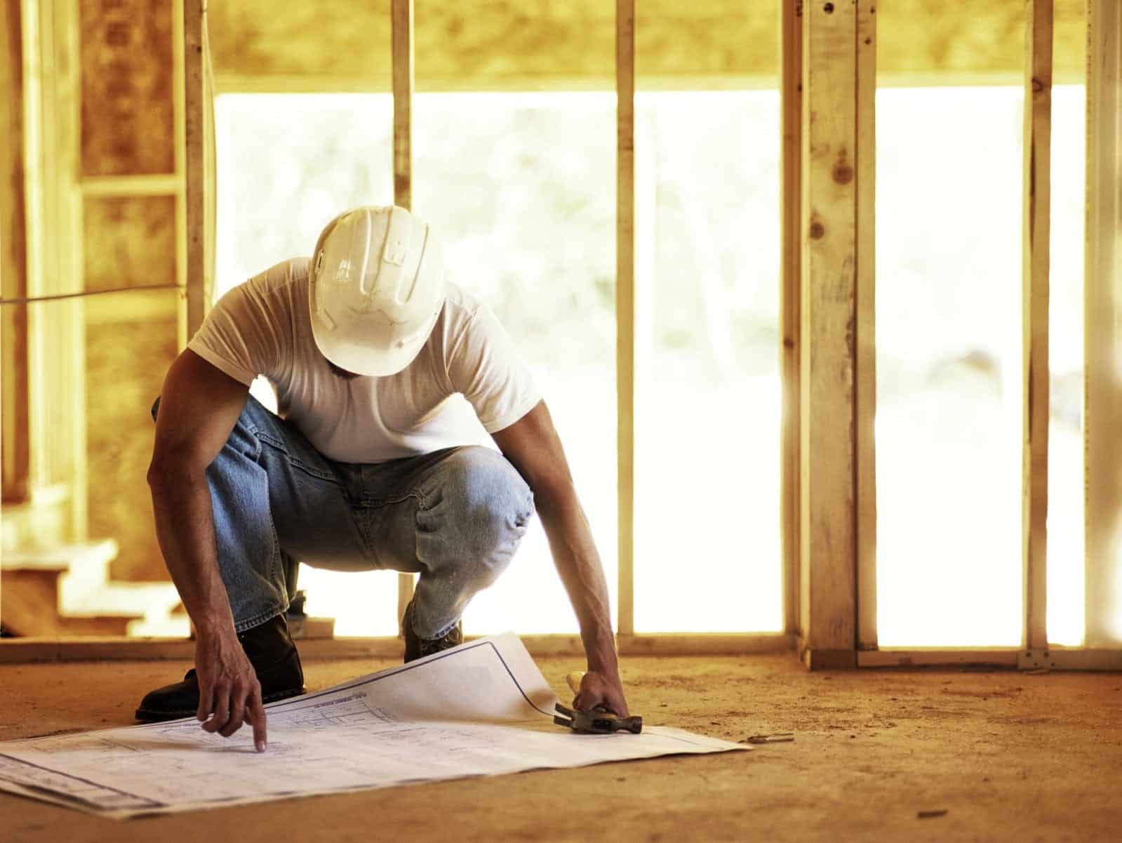 Construction Worker Reviewing Blueprints Stock Photo