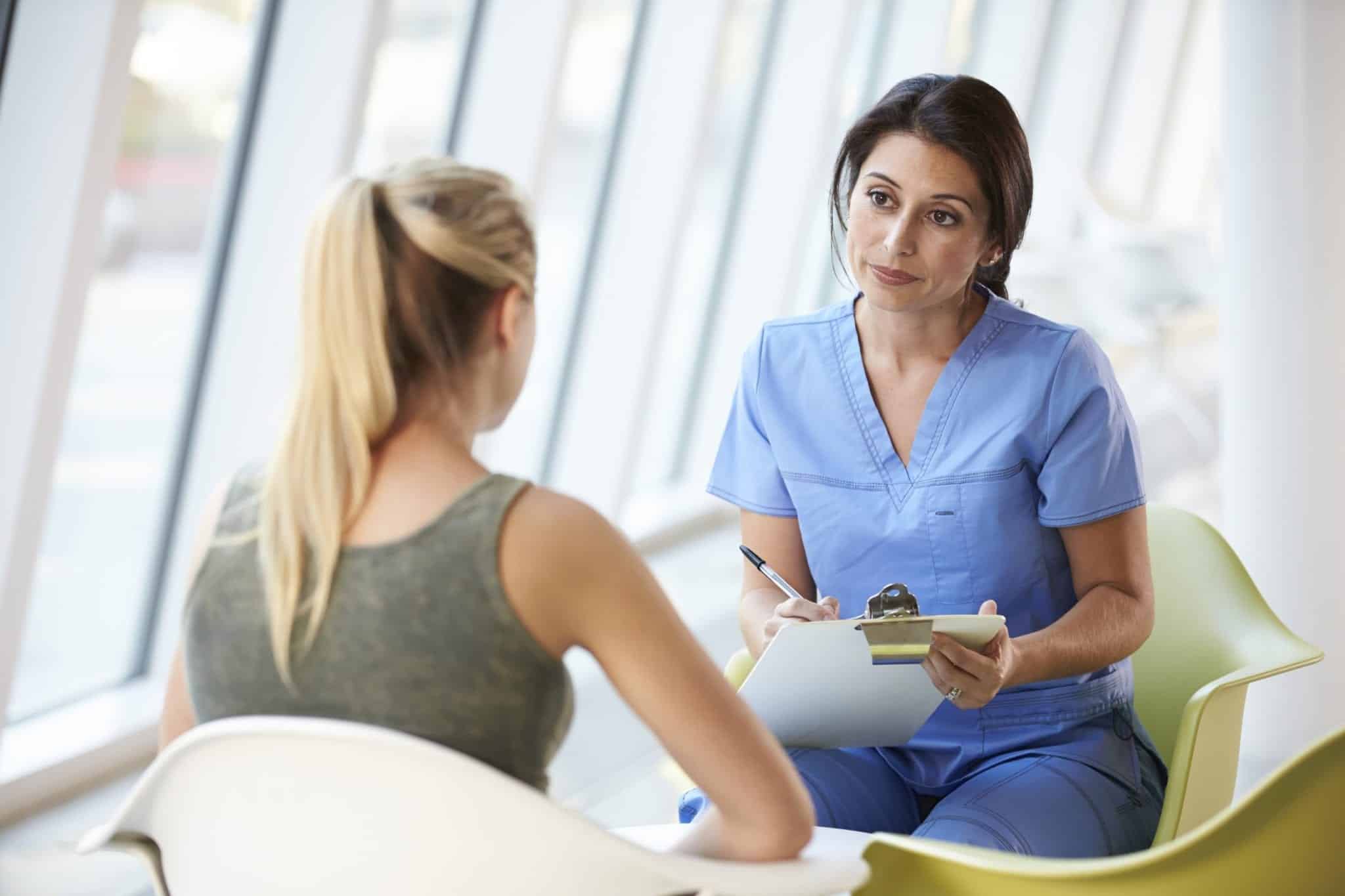 Nurse Questioning Patient's Medical History Stock Photo
