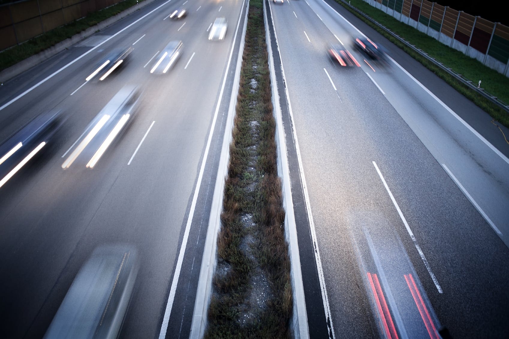 Long Lines Of Cars Driving Fast On The Highway Stock Photo