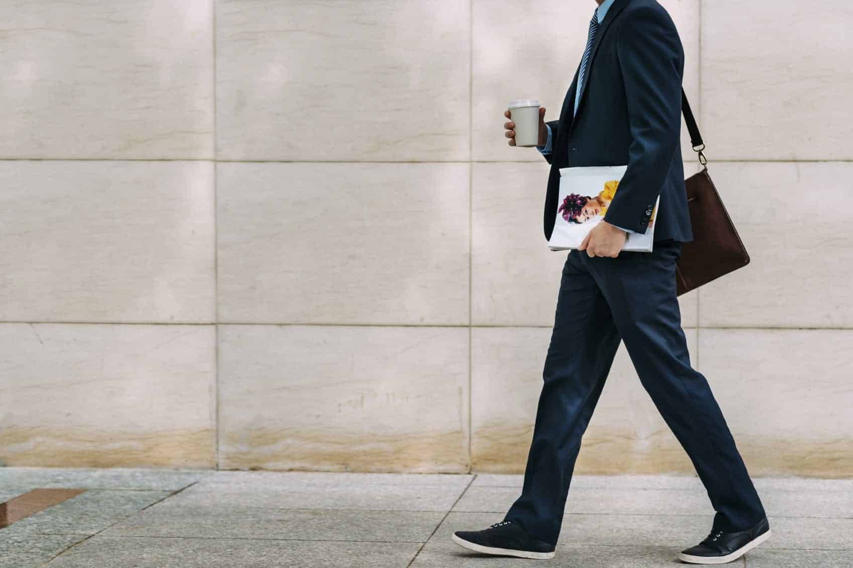 Male Pedestrian Walking Down A City Street Stock Photo