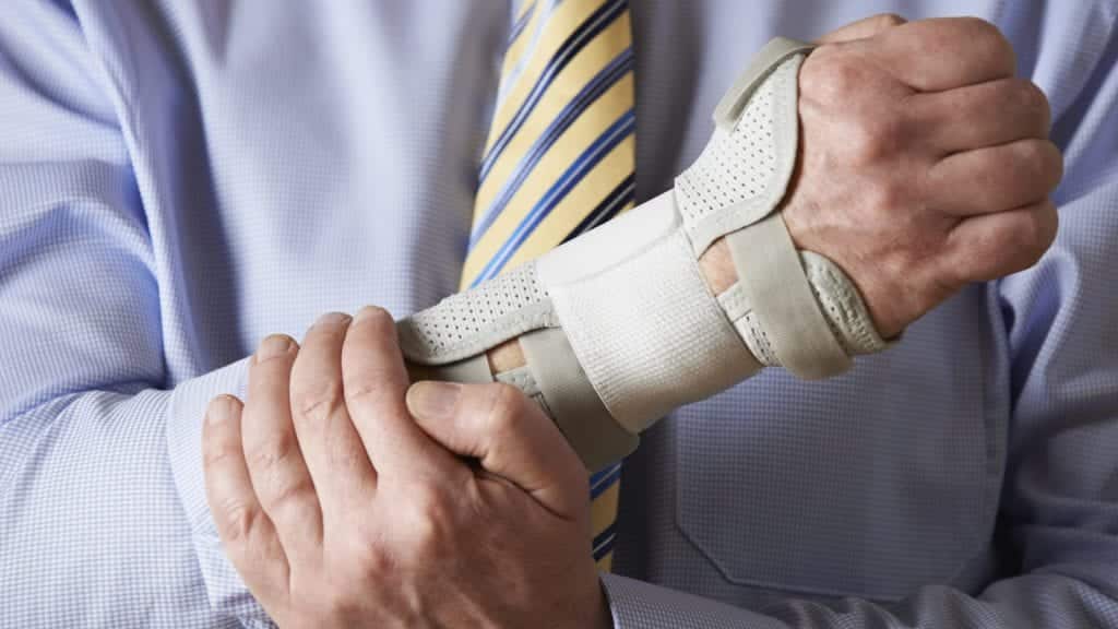 Businessman With Injured Wrist Stock Photo