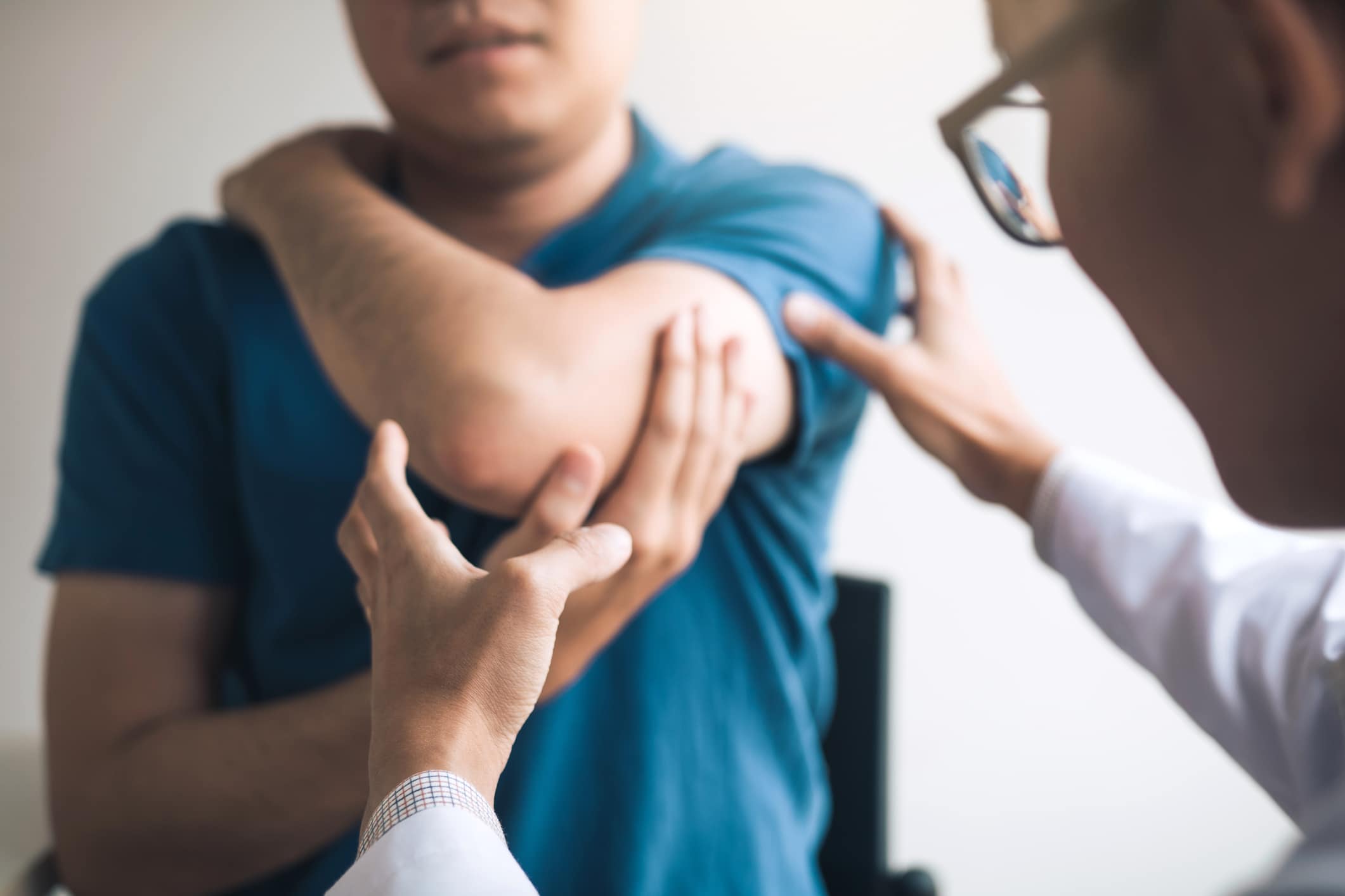 A man at the doctor after an on-the-job injury.