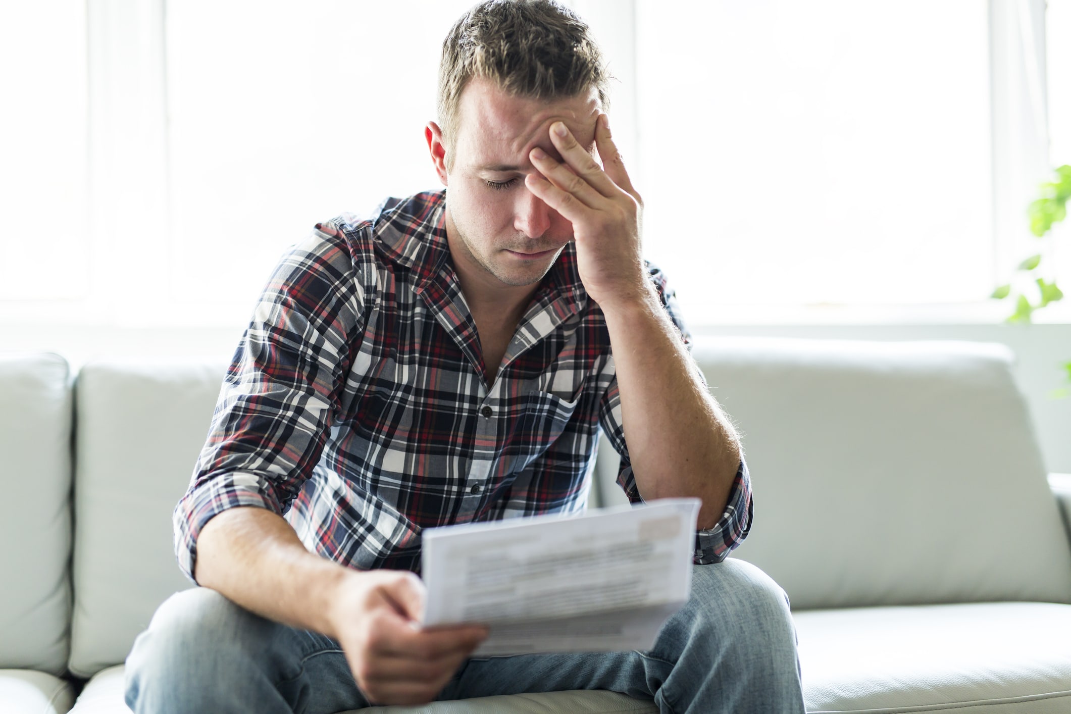 A man feeling stressed about accepting a workers’ comp settlement.