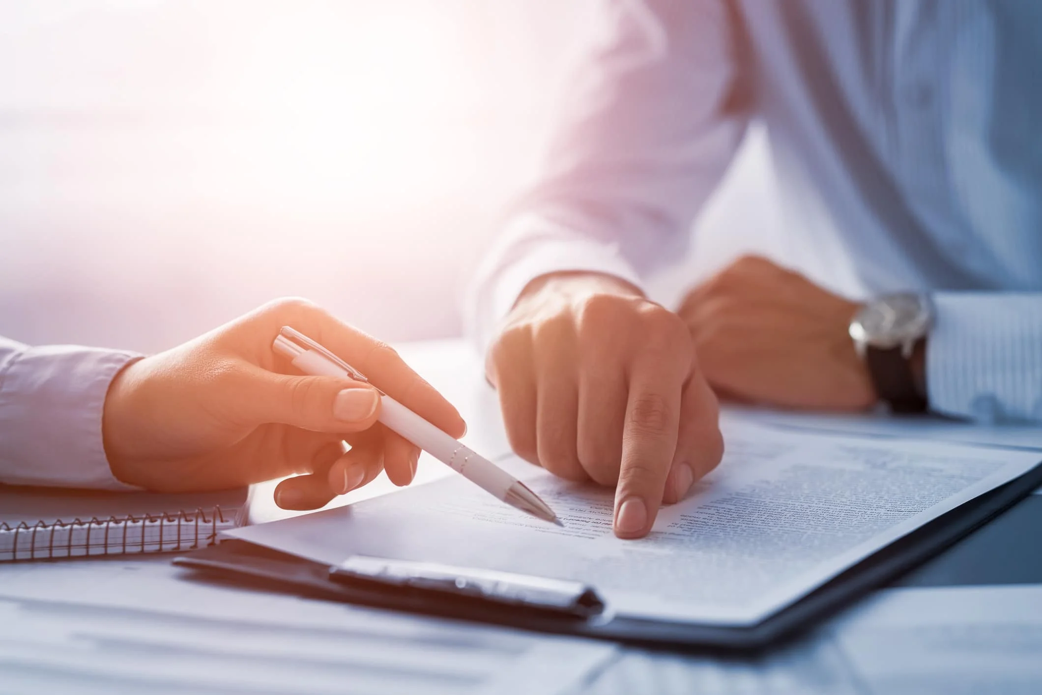 Business people negotiating a contract. It is a mistake to speak to an insurance adjuster without a professional lawyer by your side.