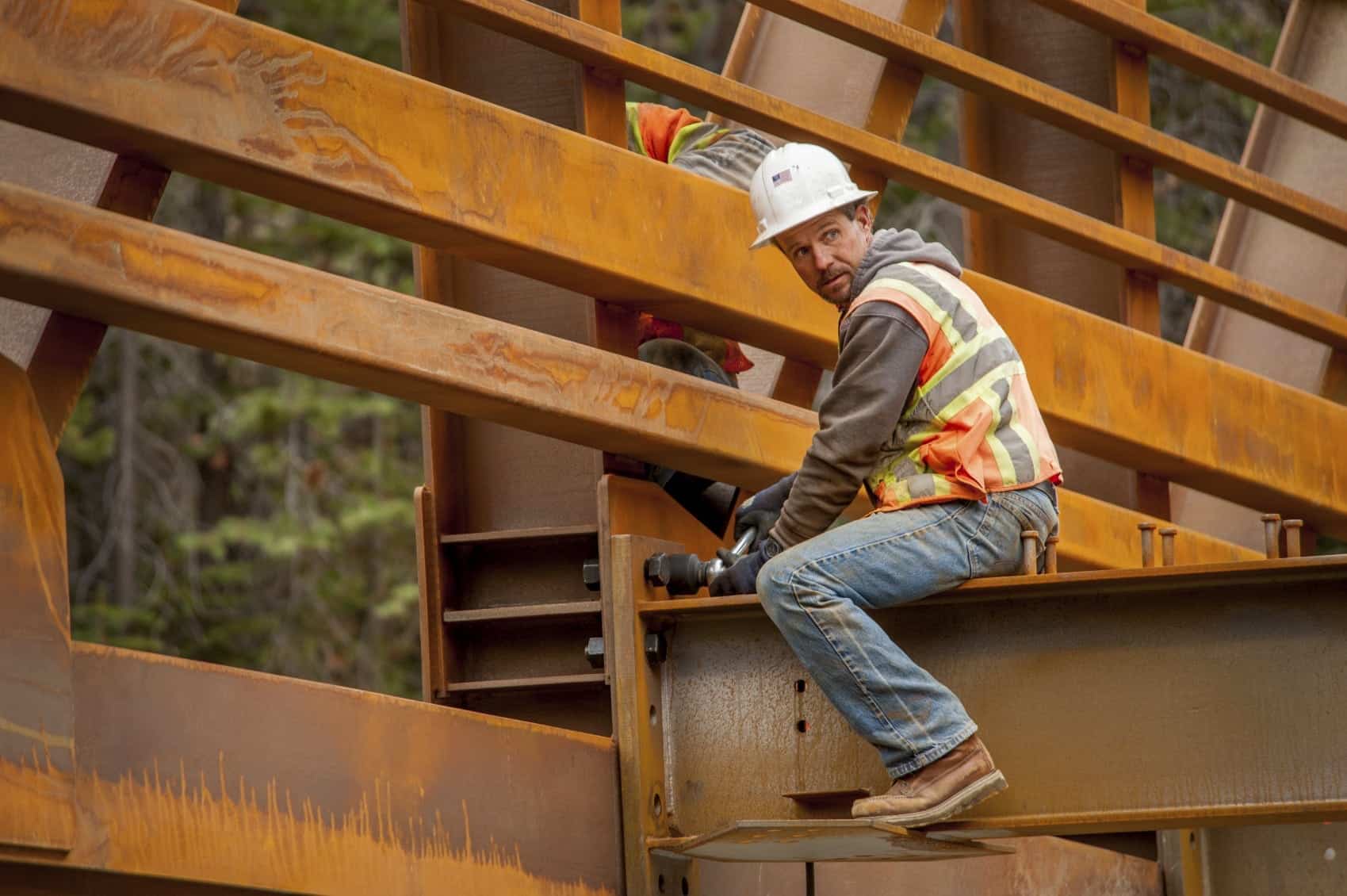 Construction Worker Working On A Large Bridge Stock Photo
