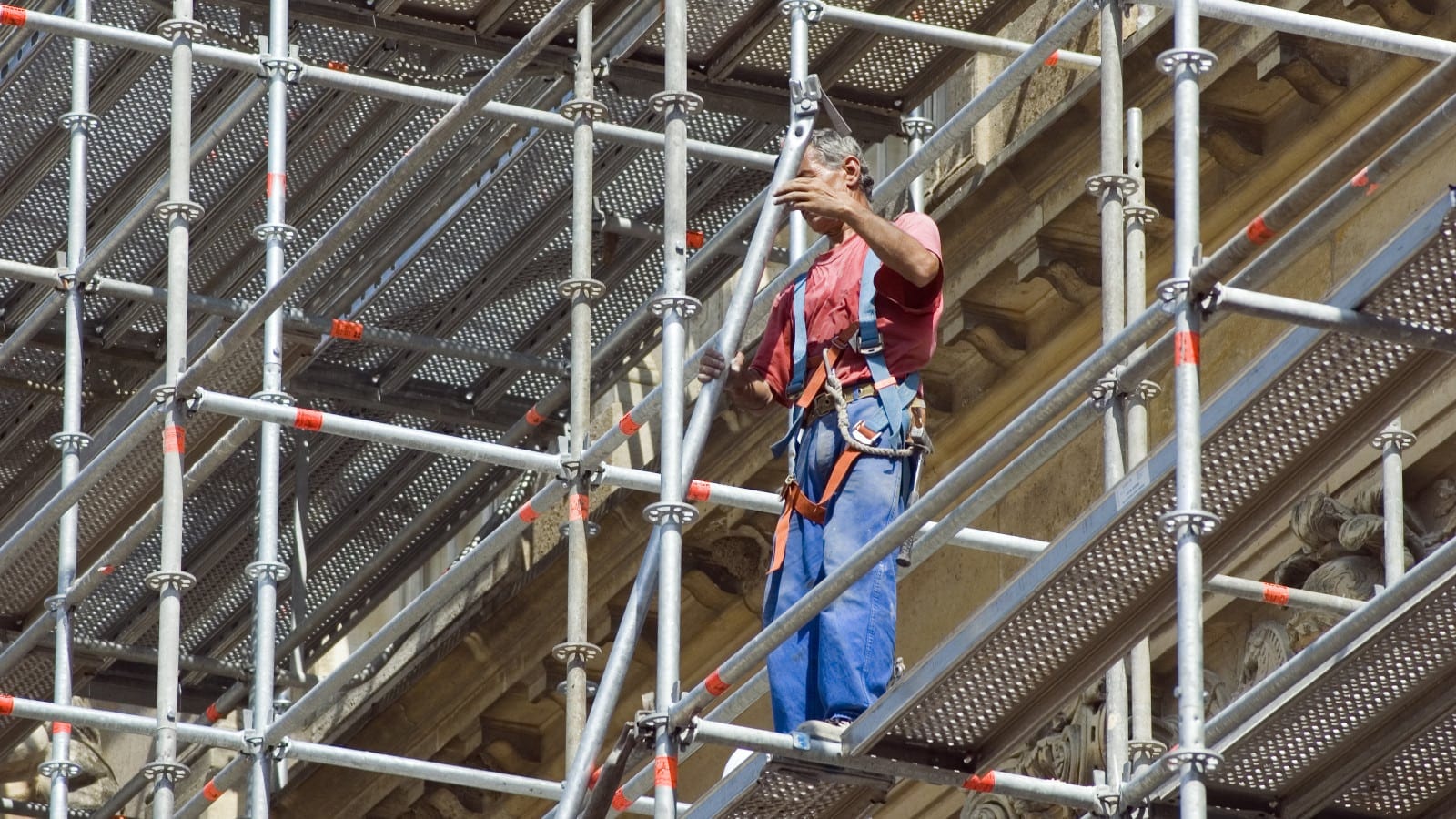Construction Worker Working On Scaffolding Stock Photo